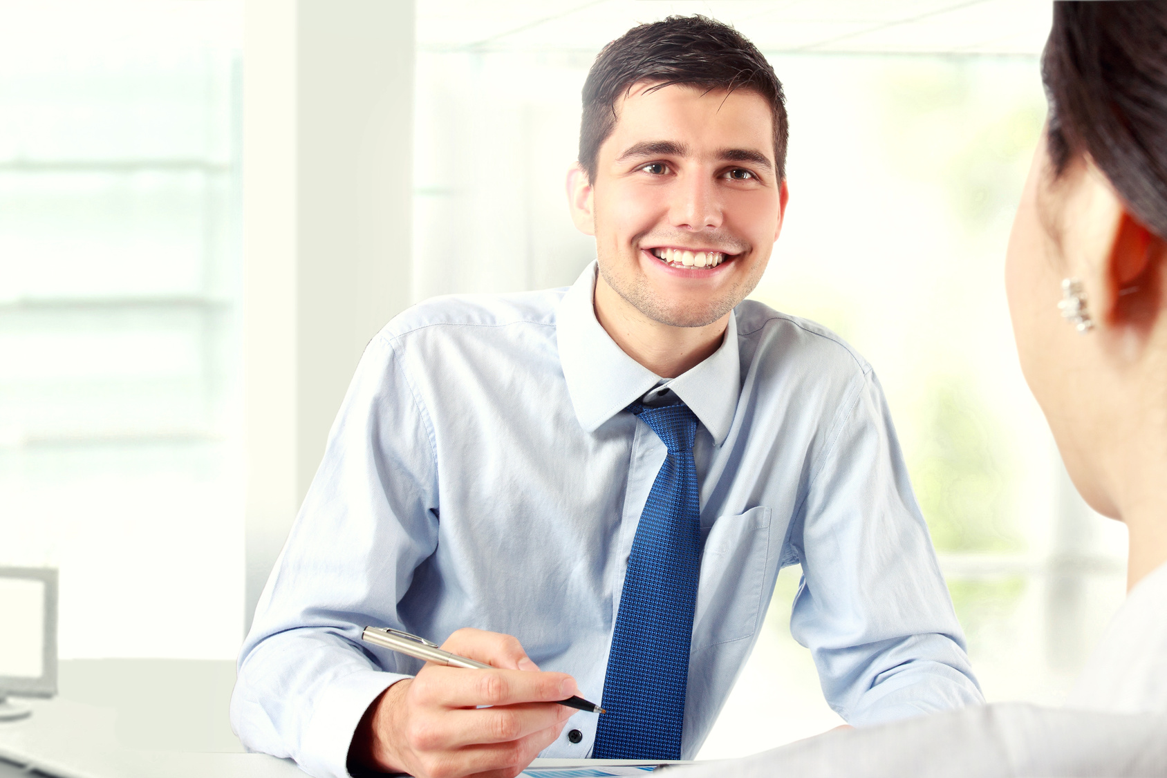 Image of young businessman interviewing female